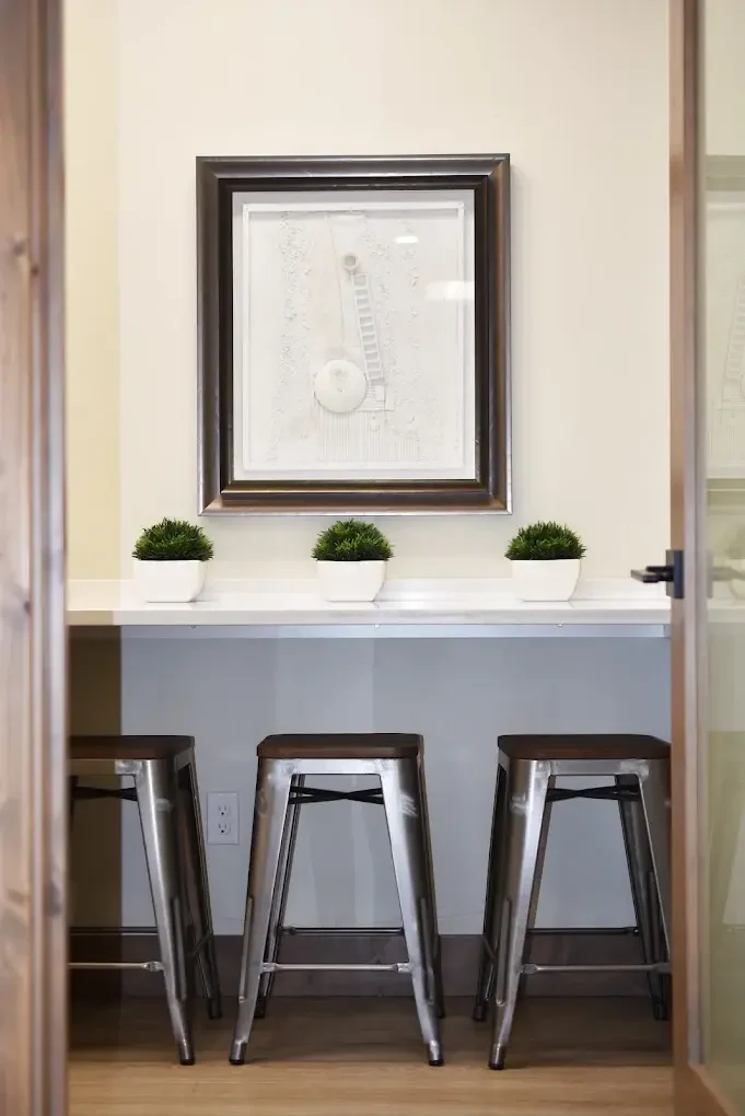McKay Orthodontics consultation nook with framed art, counter seating, and plants