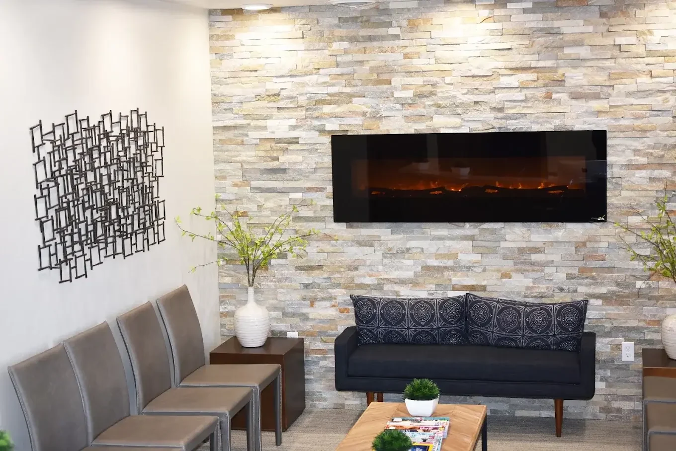 McKay Orthodontics waiting room with a stone fireplace wall, sofa, and seating