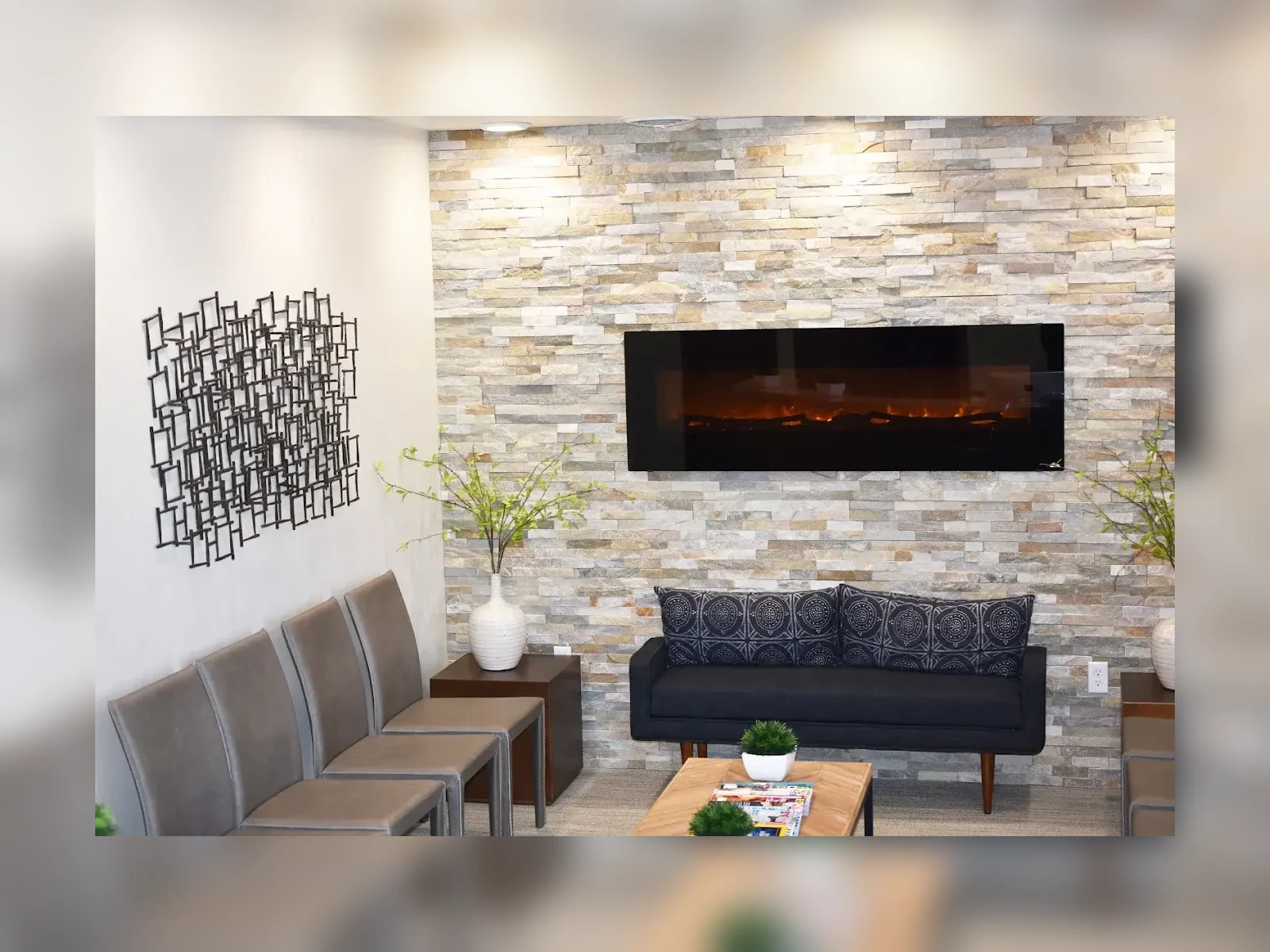 McKay Orthodontics waiting area with fireplace, seating, and stone accent wall