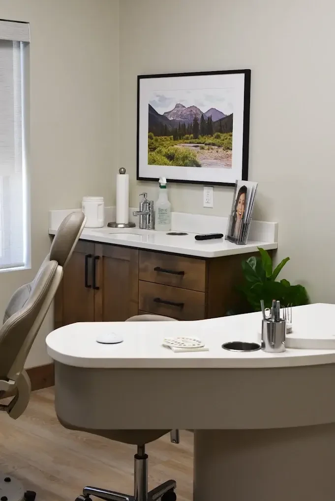 McKay Orthodontics private consultation room with a chair, cabinetry, and framed mountain art